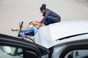 Injured cyclist hit by a car in an accident