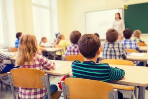 Children sat at their desks in a classroom.