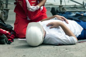 A man hurt lying on the ground after being hurt at work