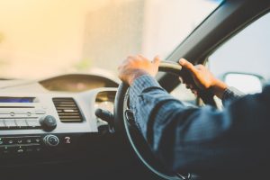 A close up of someone steering a car