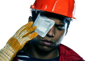 A worker with a plaster over their eye due to suffering an eye injury at work