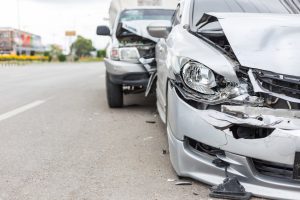 Two silver cars with smashed bonnets.