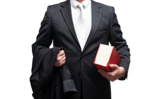 A solicitor holding a book under their arm.