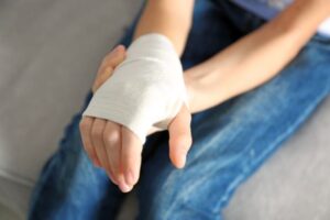 Injured person holding bandaged wrist