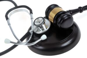 A Doctor's Stethoscope Next To A Judge's Gavel. 