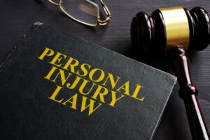 Book With Personal Injury Law Written Across It, Glasses And Gavel. 