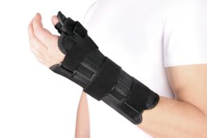 A Wrist And Hand Wrapped In A Black Bandage Because Of A Thumb Injury. 
