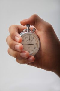 A hand holding a stopwatch. 