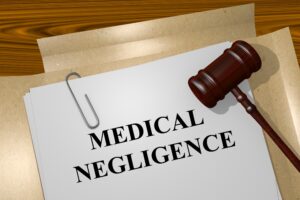 Medical negligence written on a file with a gavel hammer on top