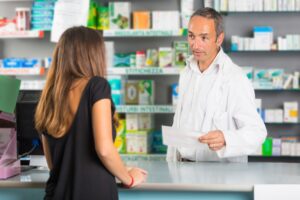 A pharmacists dispensing medications after a doctor prescribed the medication