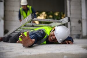 A worker trapped underneath a ladder.