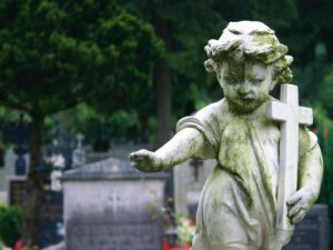 An image shows an angel in a graveyard. 