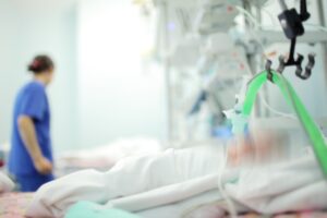 A baby lays in a NICU unit. 