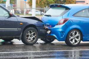A collision on a city street damages two cars and may lead to a road traffic accident claim.