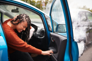 A woman has suffered whiplahs in a car park accident.