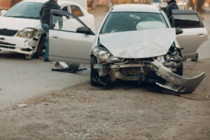 A crashed car is beside the road. 