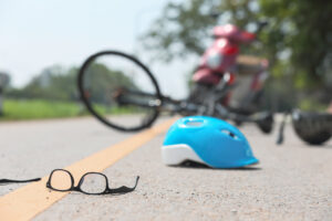 A discarded bicycle, helmet and glasses after an accident
