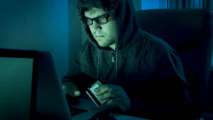 A hacker using stolen credit cards to access personal accounts.