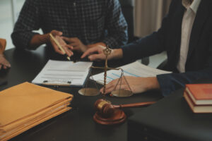 A laser negligence solicitor with a client reviewing a contract. 