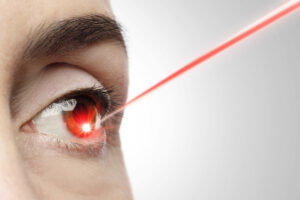 A laser pointing at a person's eye. 