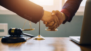 Solicitor and his client shake hands 