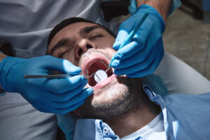 A dentist carries out a dental procedure.