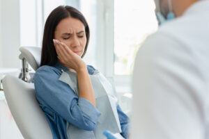 Woman in pain in a dentists chair