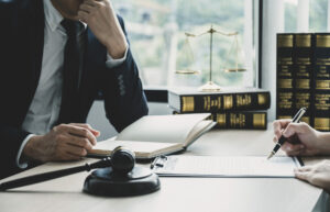 Lawyer sat at desk with notebook.