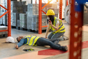 A supervisor calls for assistance after a worker is injured due to inadequate safety procedures