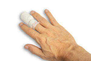 A hand with a bandaged middle finger.