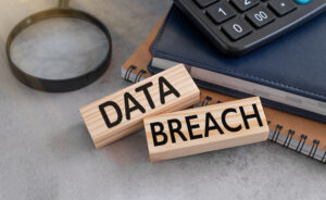 A pair of wooden blocks next to each other with the words 'data breach'