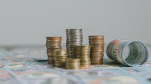 Piles of coins on top of bank notes to represent examples of medical negligence payouts in the UK.