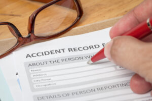 Someone filling out an accident record form