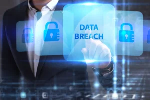 A man in a suit stands behind a graphic displaying the words 'data breach.'