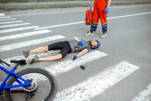 The accident scene of a cyclist knocked off their bike with a severe leg injury 